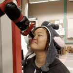 a robot arm holding a student's nose