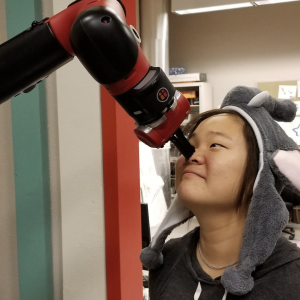 a robot arm holding a student's nose