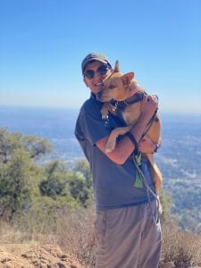 Photo of Adriel Ghadoushi with their dog on a hike